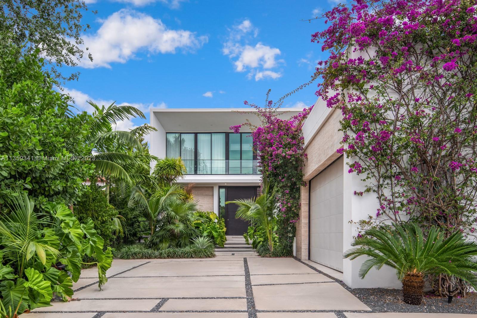 Step Inside With Me! Draped in bougainvillea, this modern waterfront on coveted lower North Bay Road
