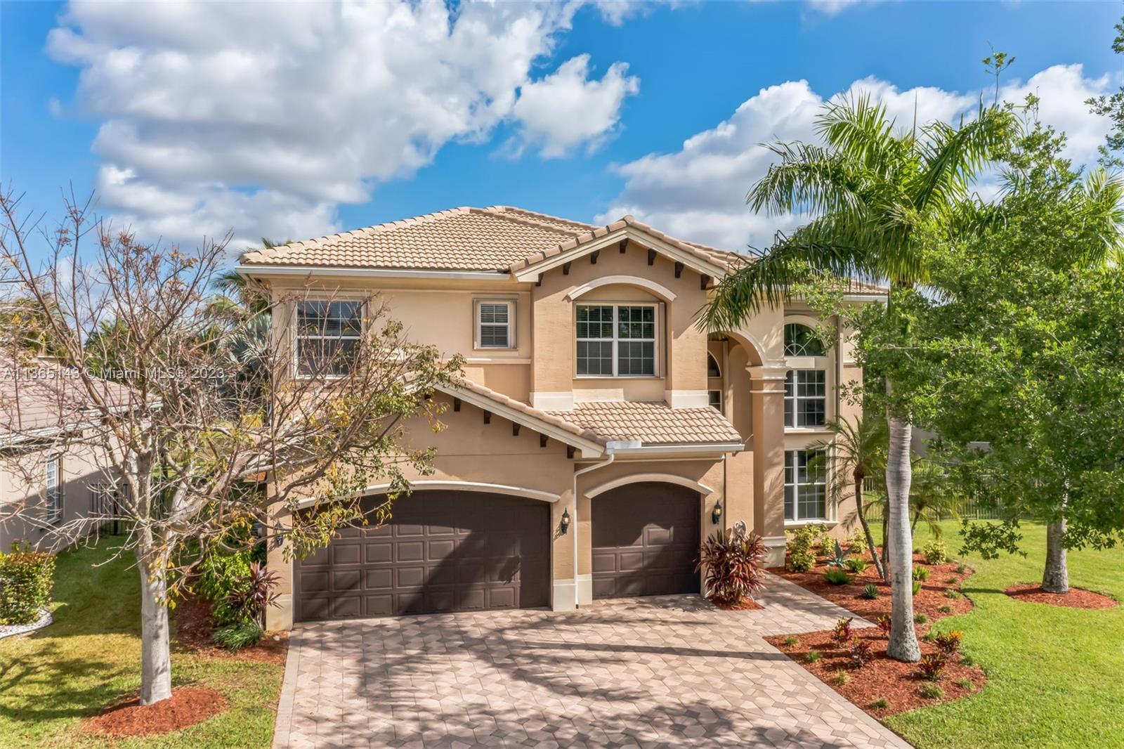 Elegant lakefront home in the charming Canyon Springs community. The front entrance reveals a majest