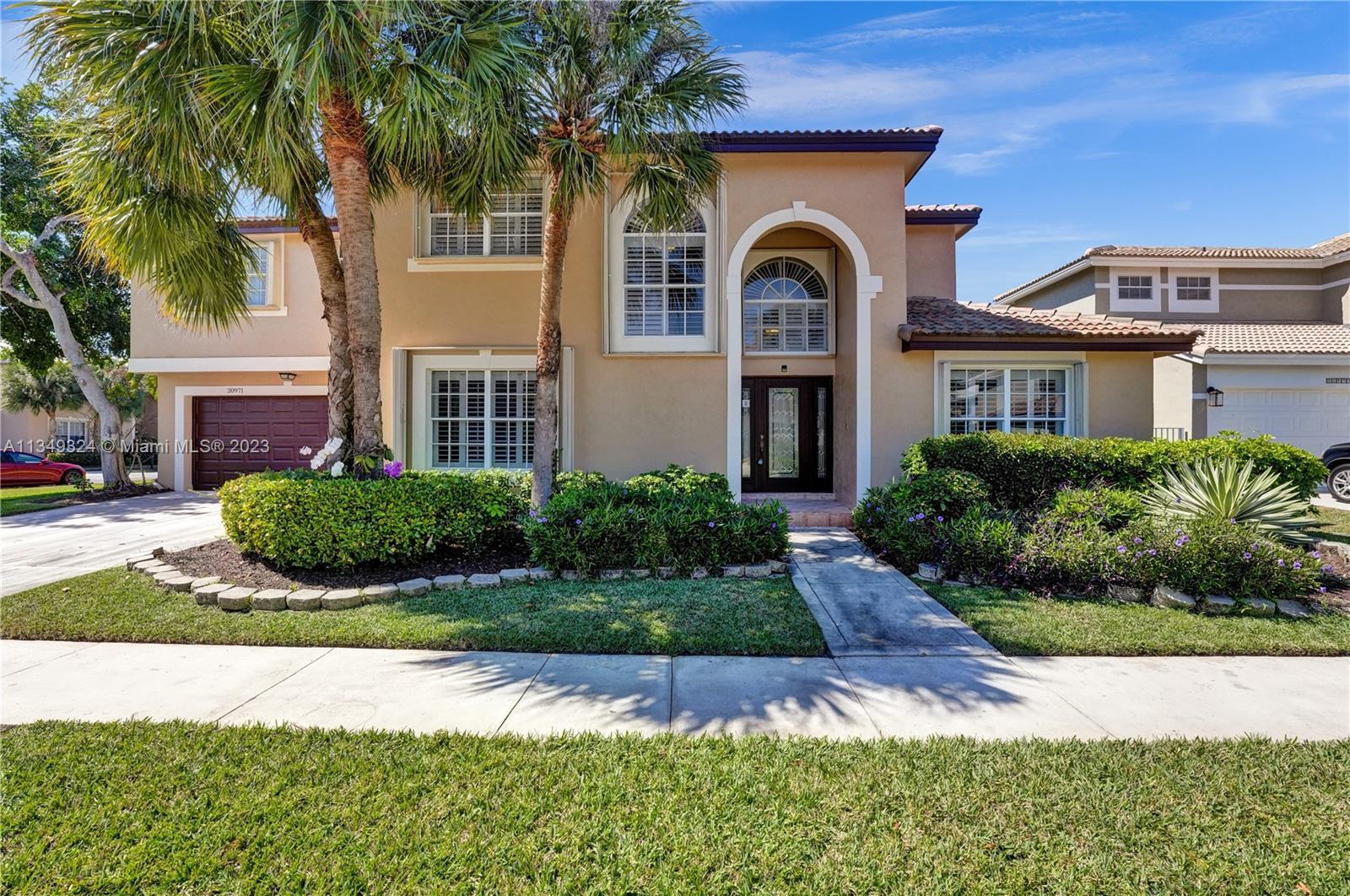 This gorgeous two-story contemporary home situated in the prestigious gated community of Regatta in 