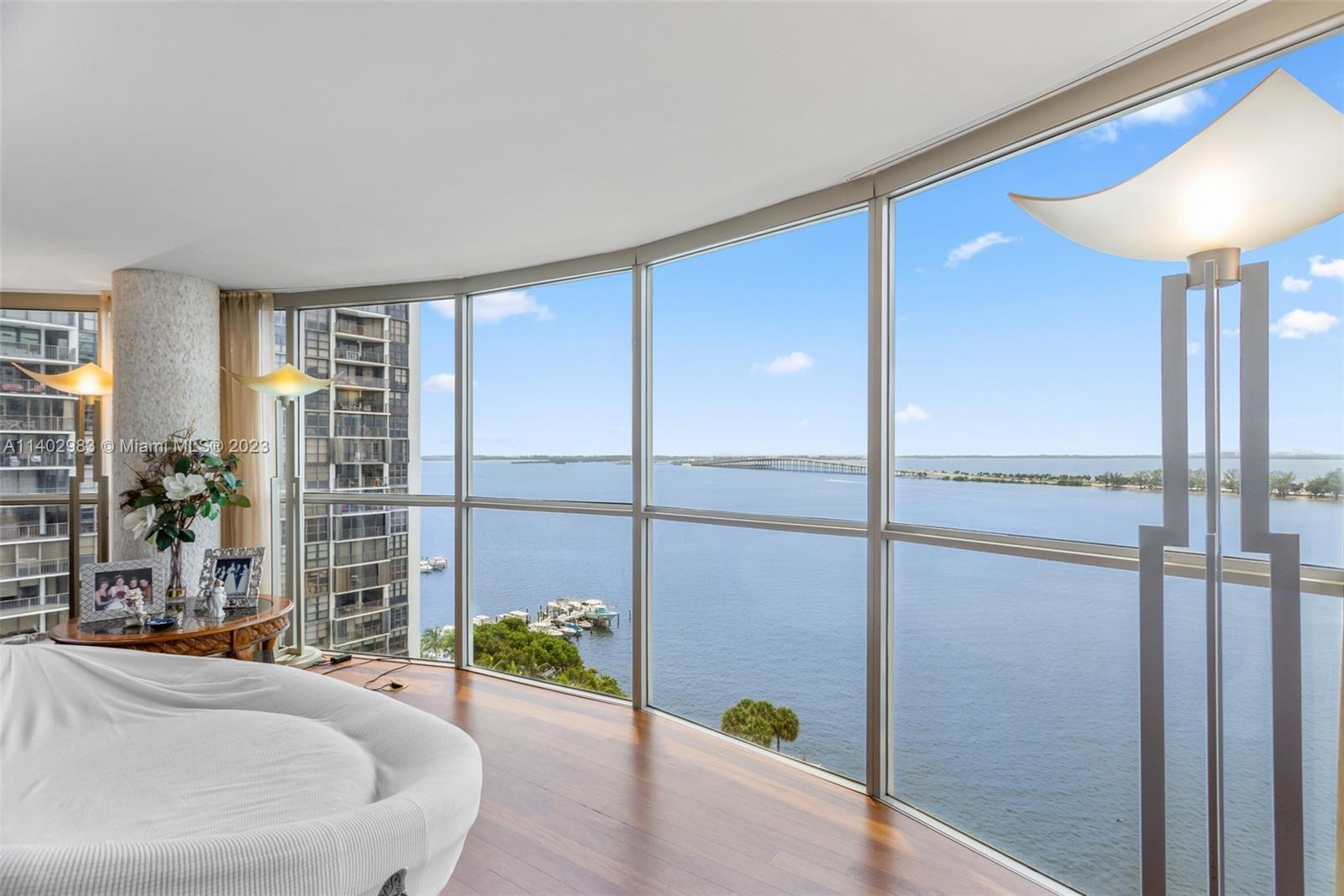 Prepare to be mesmerized by breathtaking 180-degree unobstructed views of Biscayne Bay, visible thro