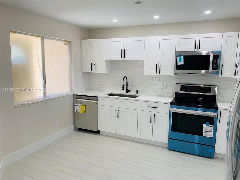 This remodeled townhouse offers an open concept and new flooring throughout. The kitchen features cu
