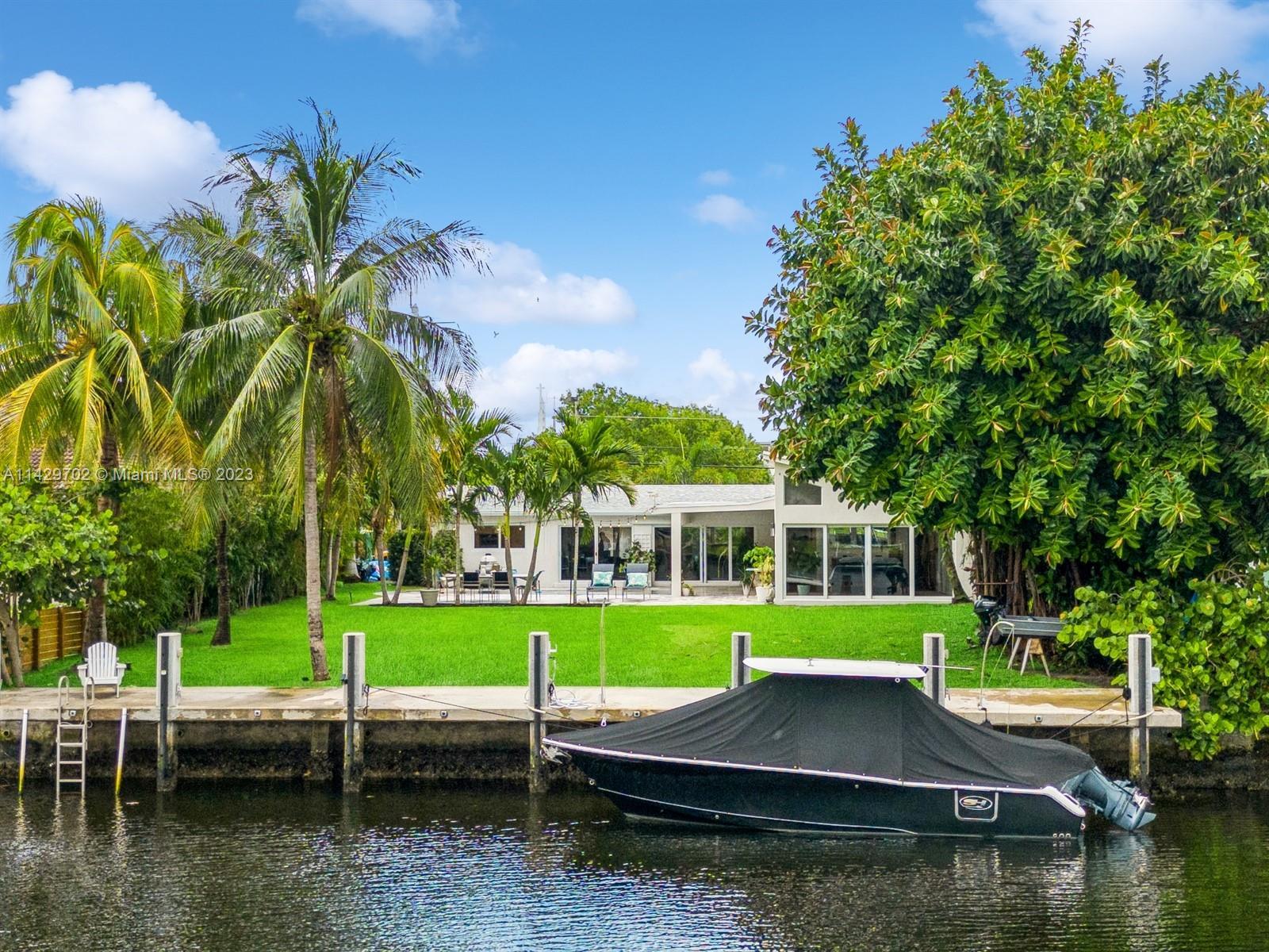 Urban oasis & boater's dream on an oversize lot. In this lush and private house & backyard, one woul