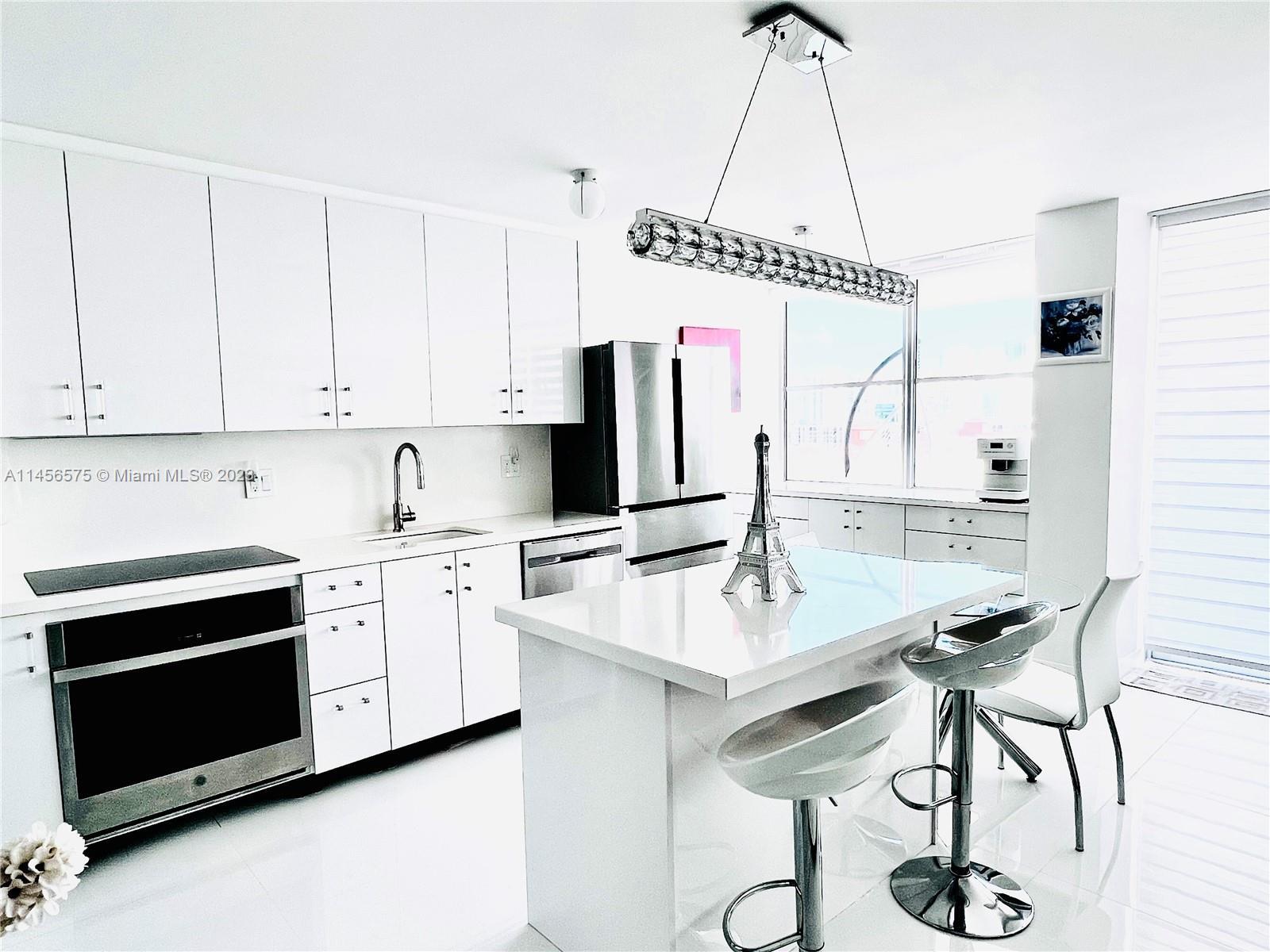 Step into this recently renovated all-white apartment and prepare to be captivated by its elegant ch