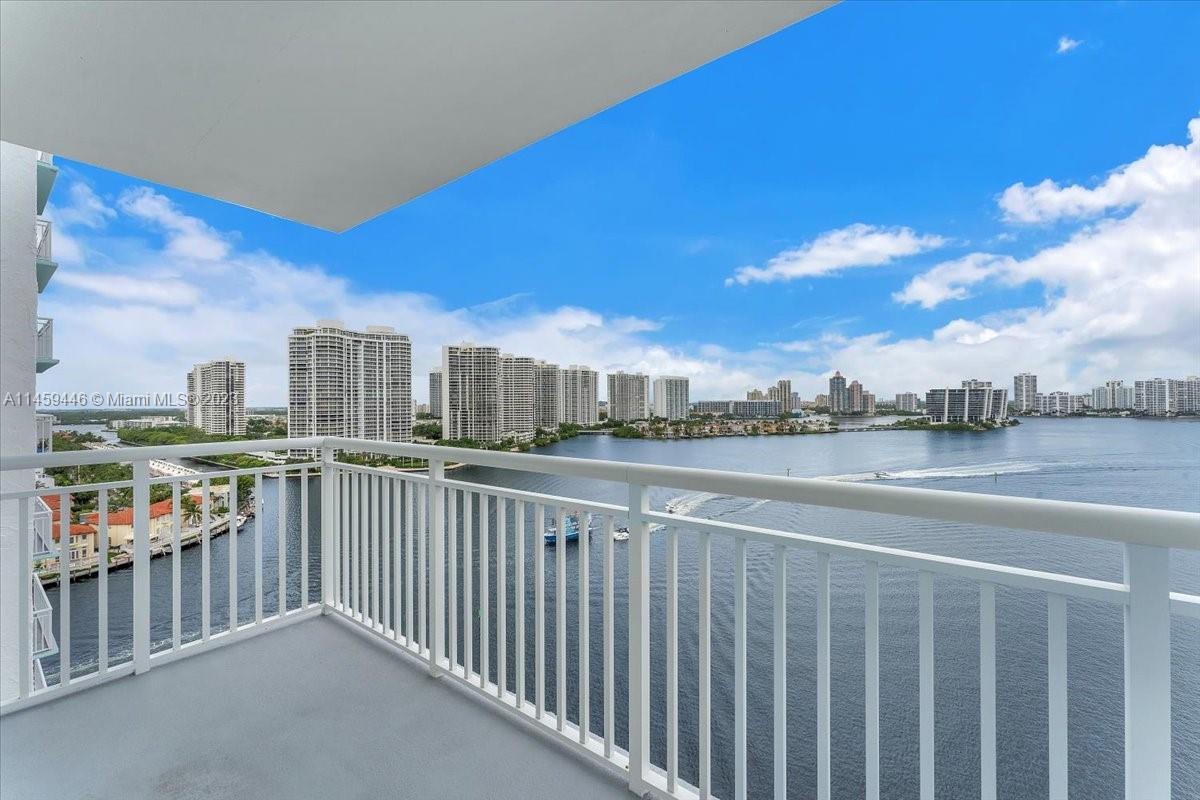 Welcome to this stunning corner unit offering breathtaking panoramic views of the bay, intercoastal 