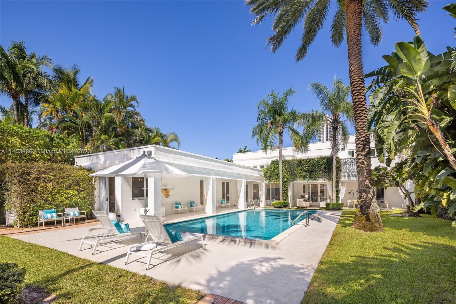 Palm Beach Meets Miami Beach! This beautiful Contemporary waterfront home sits on a lushly manicured