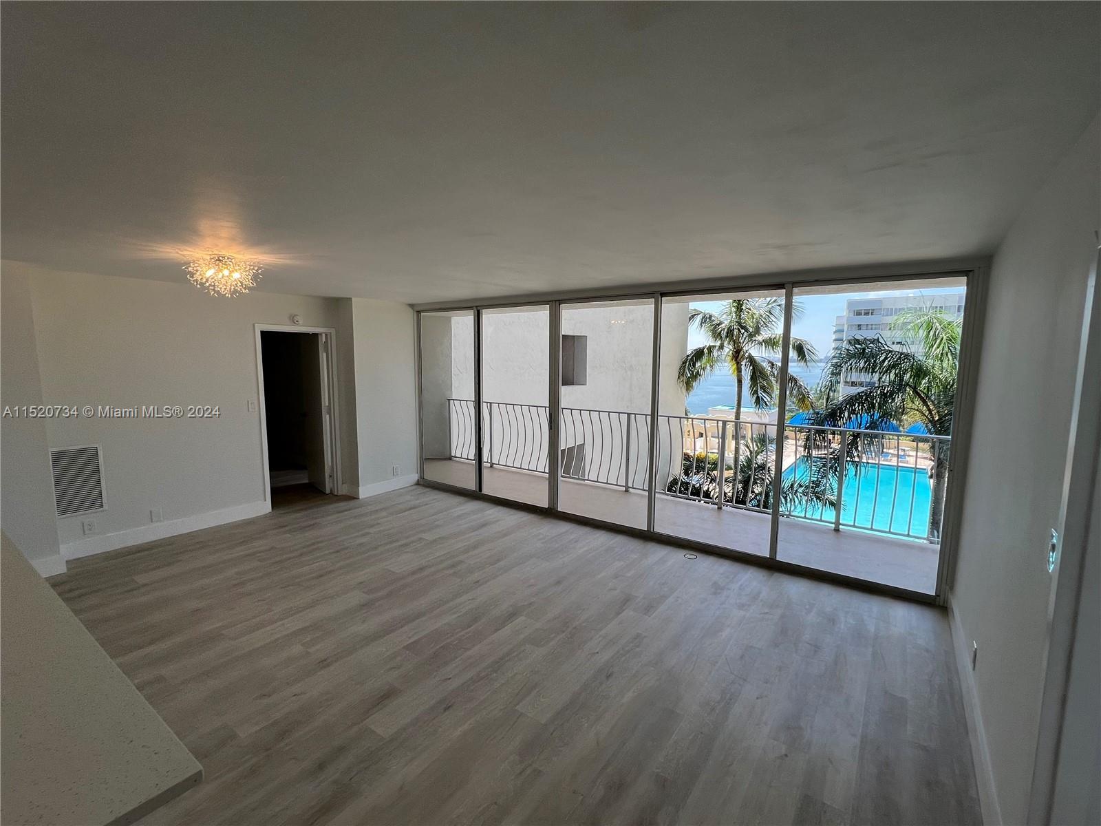 Beautifully remodeled 2bed/2bath unit with water views overlooking renovated swimming pool & tropica