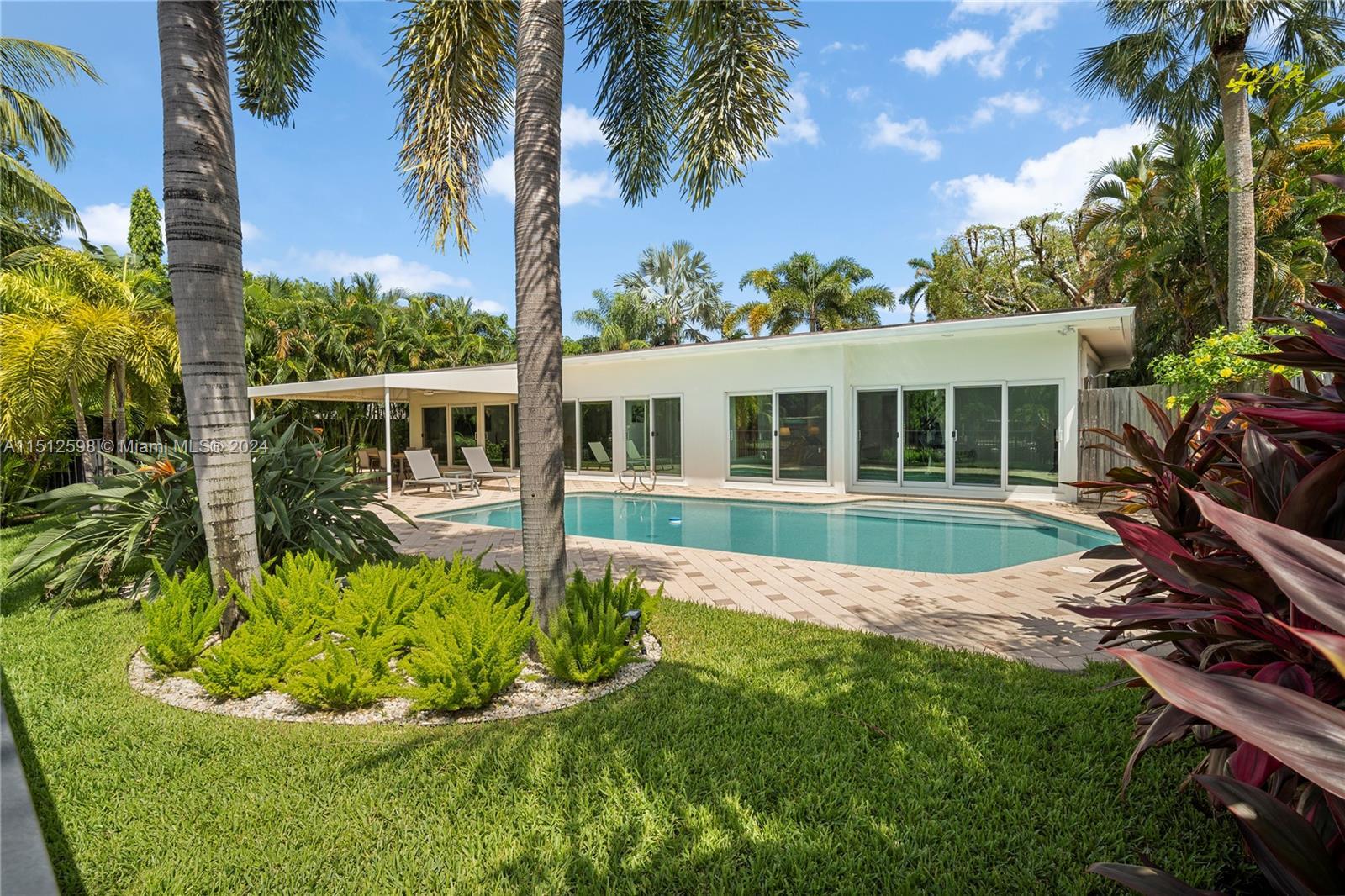 Midcentury Modern meets classic Florida in this beautiful 3/3 open-concept waterfront oasis. Fully r