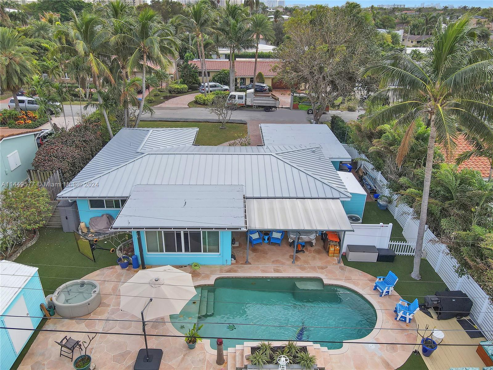 Spacious pool home in sought-after Bel-Air situated in charming beach town. Custom metal roof, flat 