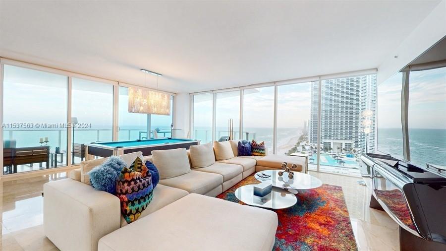 Experience unparalleled luxury in this 4-bedroom, 4.5-bathroom oceanfront condo nestled within the p