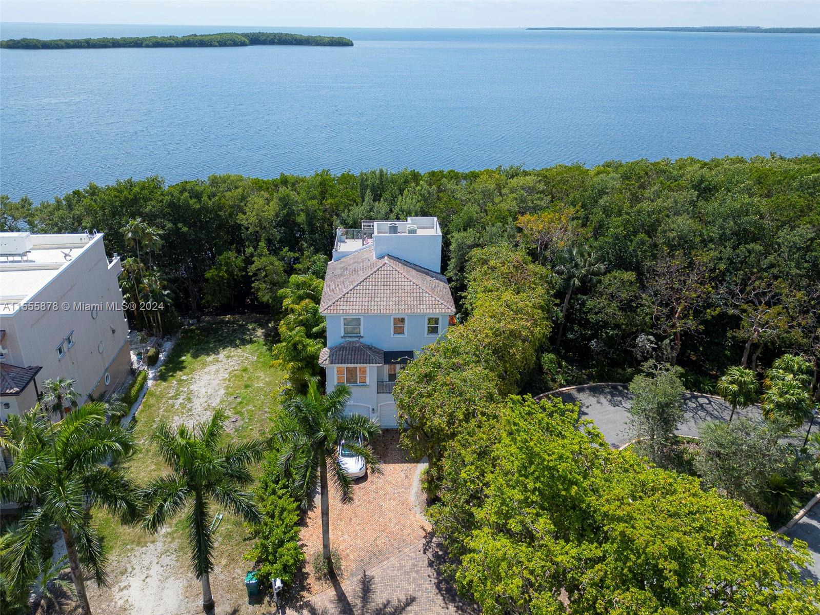 Enjoy the breathtaking water views from this amazing BAYFRONT 4 story home in Paradise Point. A priv