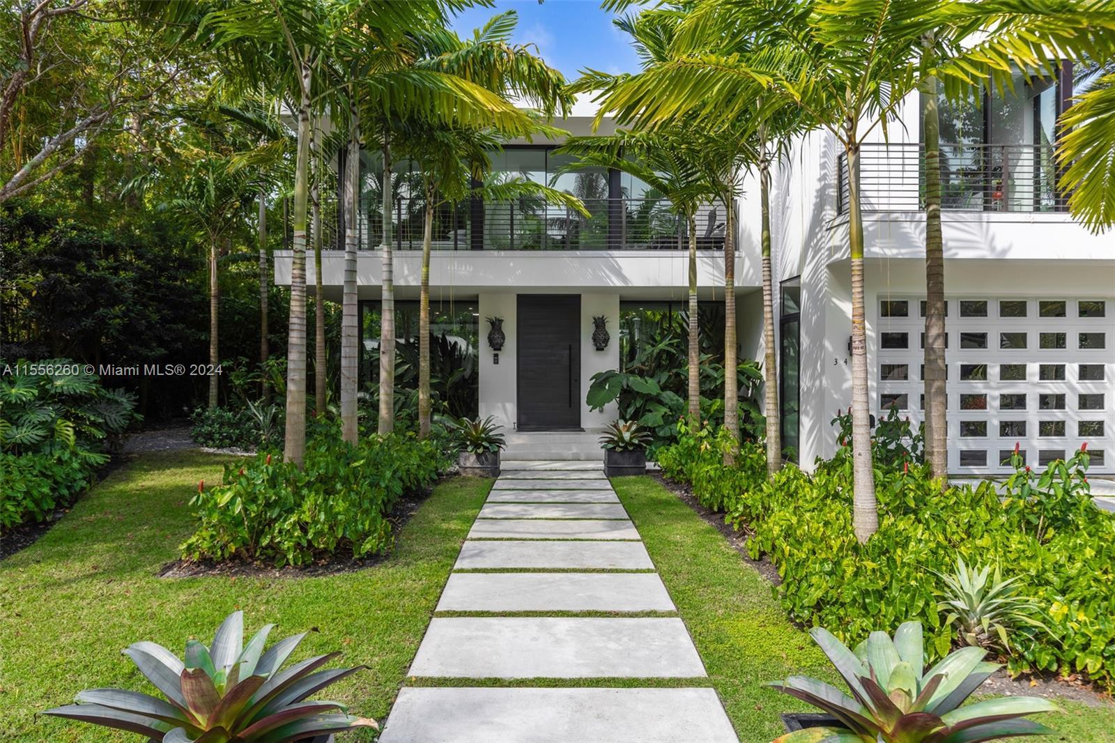 Stunning tropical modern home in the coveted guard-gated community of Four-Way Lodge Estates. Walk t