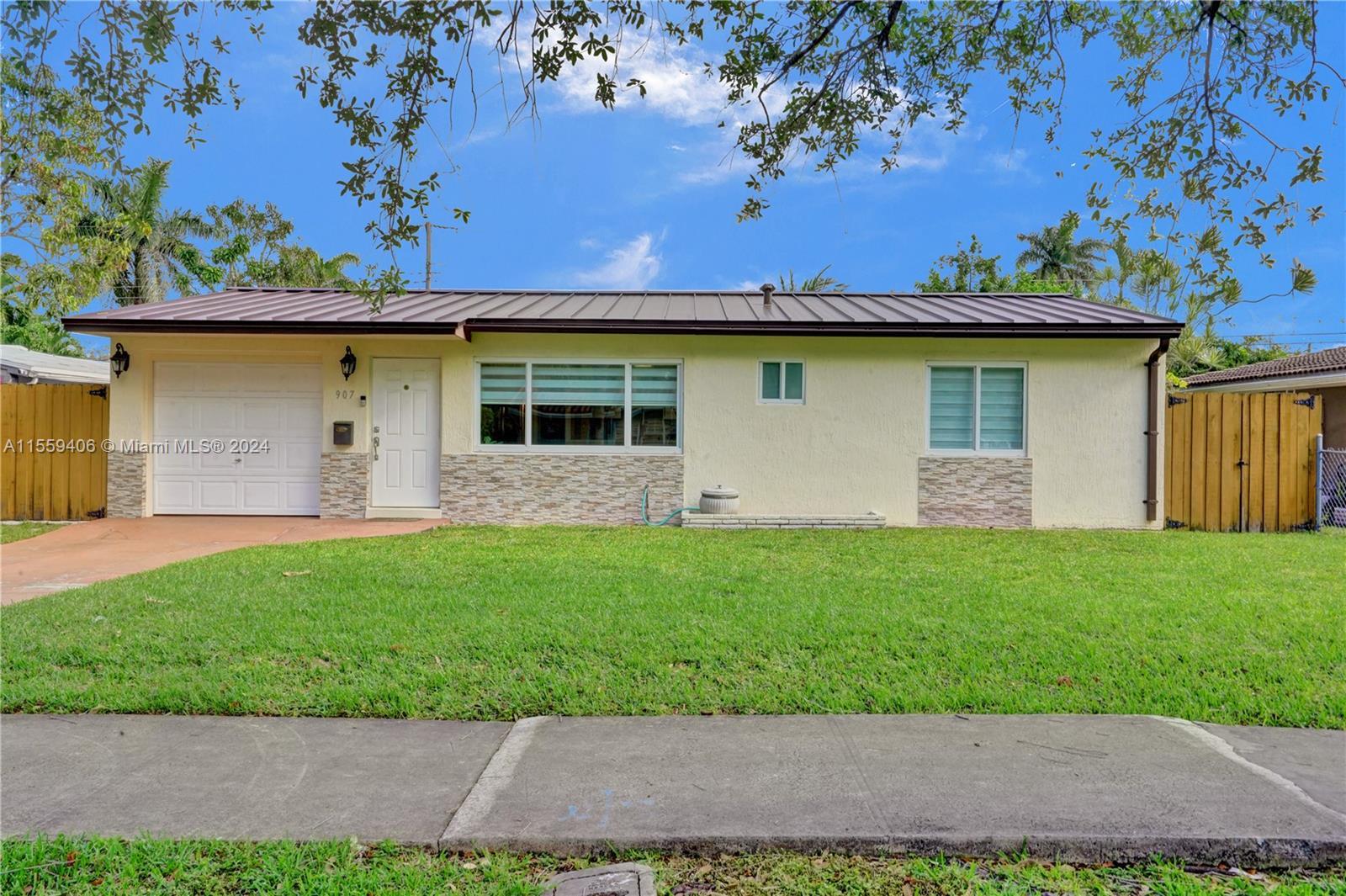 This beautiful home is located on a quiet tree lined street in the heart of Hallandale Beach. This a
