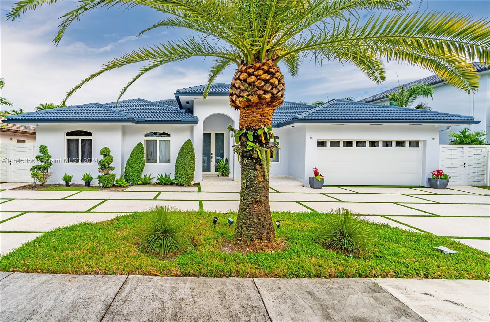 Step into unparalleled elegance in Miami Lakes with this masterfully remodeled residence, where ever
