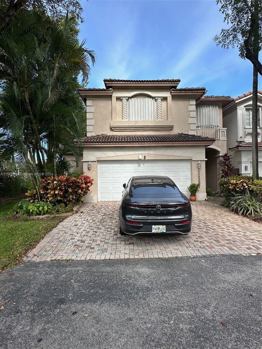 Resort style living in this spacious 4/2.5 DORAL ISLES Coach home with 2 car garage. Easy access to 