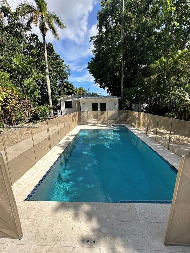 TROPICAL OASIS LOCATED IN THE HEART OF COCONUT GROVE. YOU WILL BE GREETED BY A BRAND NEW SWIMMING PO