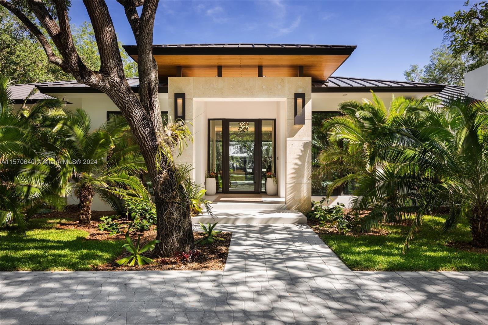 This custom-built, new construction home in Pinecrest exudes luxury, tranquility + style at every tu