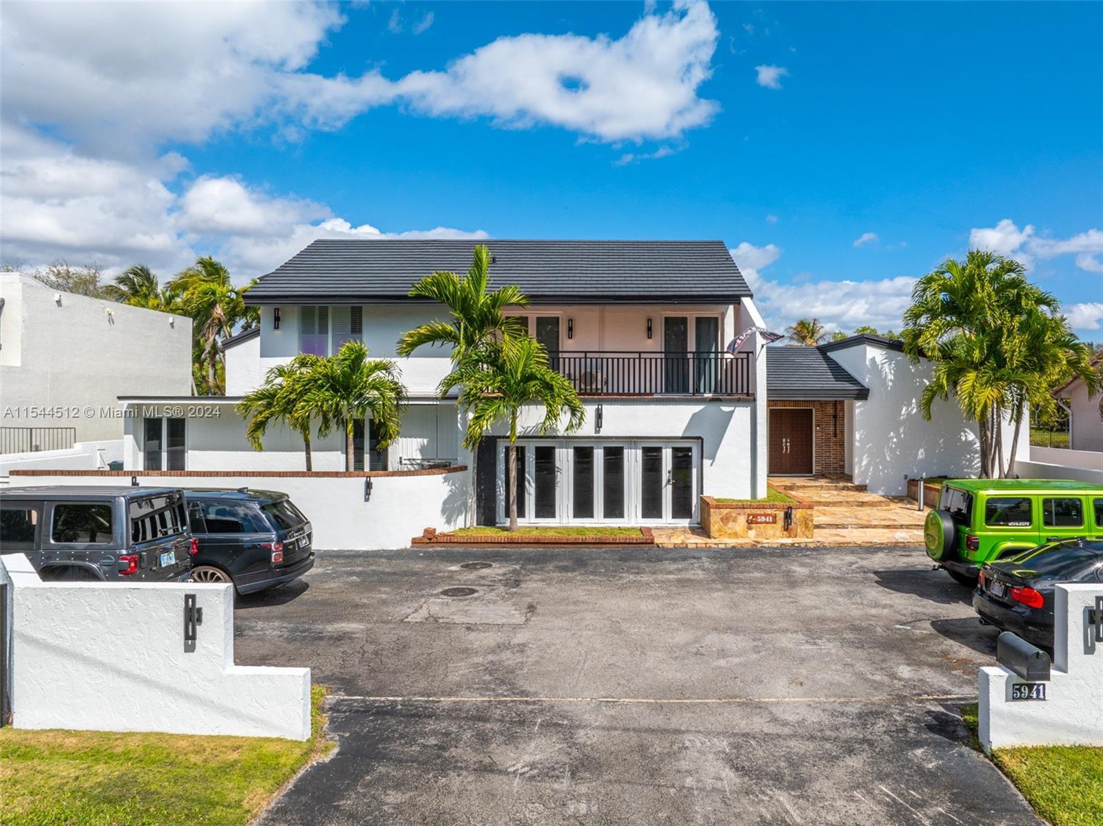 Nestled on the border of South Miami & Pinecrest, this 2-story waterfront mansion offers the epitome