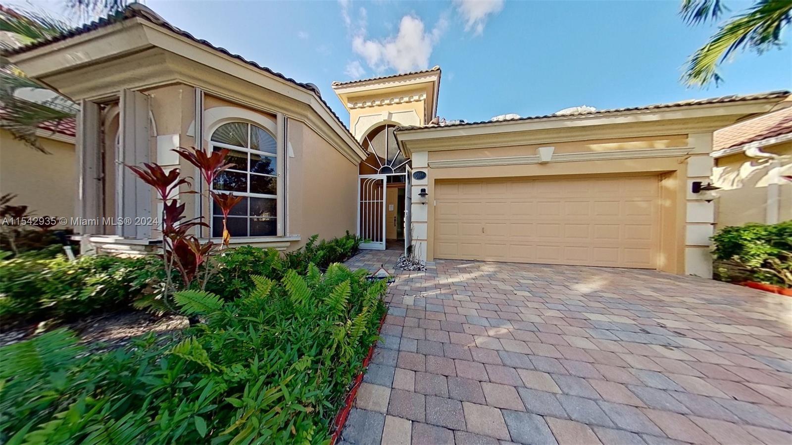 Spacious Home within the 55+ Gated Community of Mizner Falls featuring 3 beds, 2.5 baths, 2 cars gar