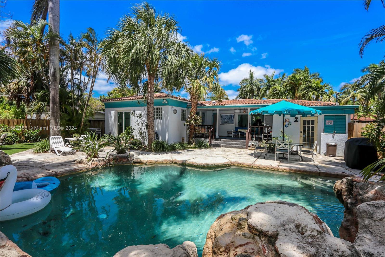 Your private tropical paradise awaits in this stunning home with a lush backyard straight from a mag