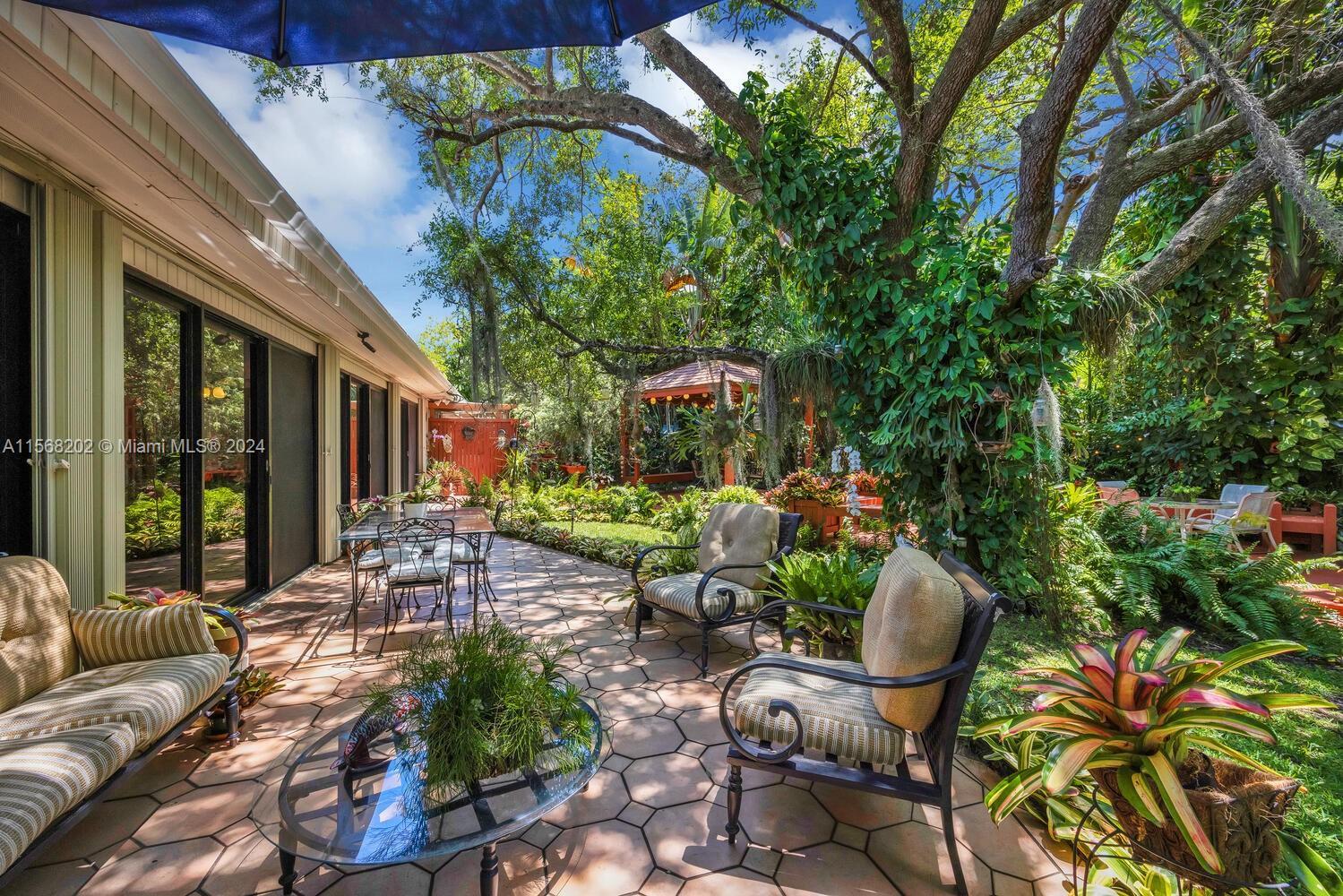 Reminiscent of Fairchild Tropical Garden, this very private oasis will delight & enchant you w/ its 