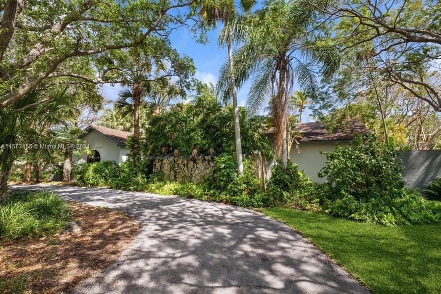 Lovely Palmetto Bay residence full of warmth and charm* Located on a quiet street * Lush tropical la