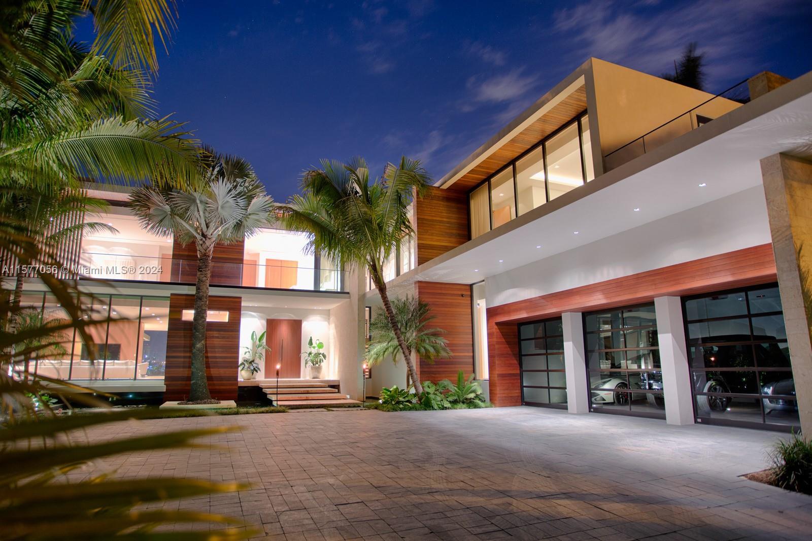 Stunning modern waterfront estate with unobstructed views of Downtown Miami Skyline located on Hibis