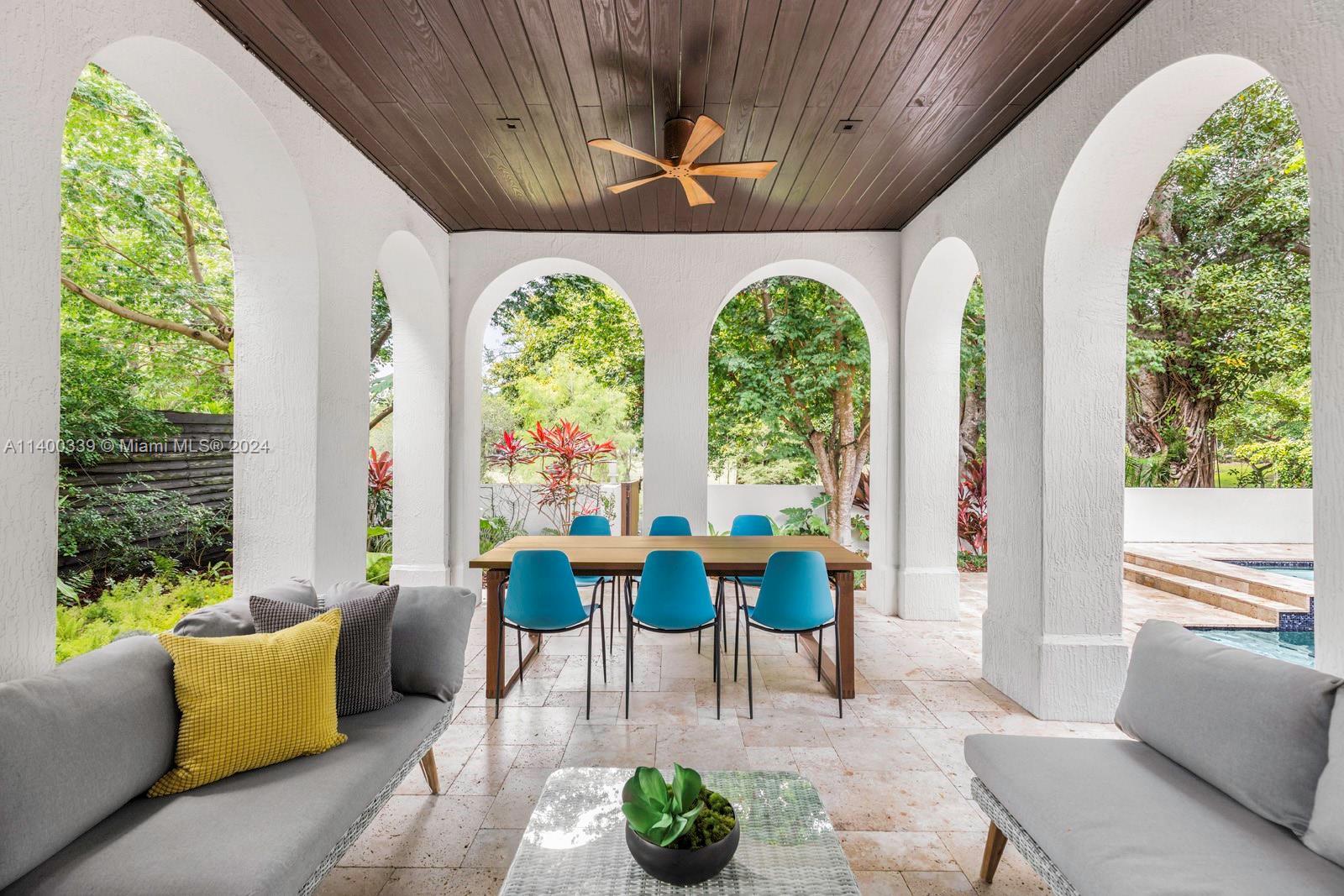 Stunning home on a quiet street in lush South Coconut Grove. Light-filled interiors with a modern vi