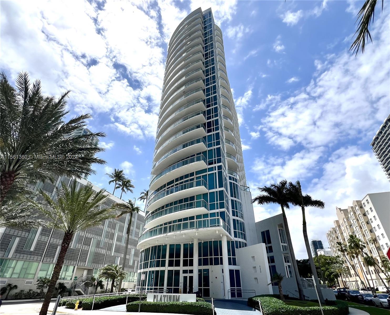 Beautiful oversized modern condo with 1 bed/1 1/2 baths, two curved glass balconies, and floor-to-ce