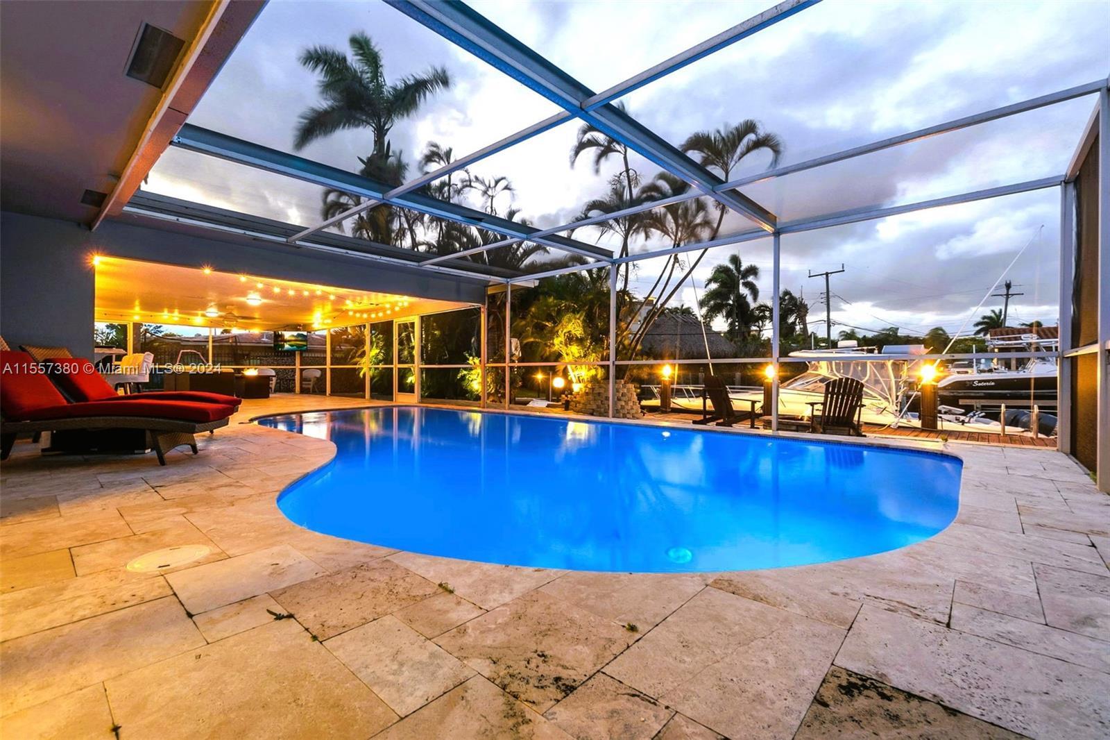 South Florida living at its finest with this stunning 3 bed 3 bath pool homel with 75' dock and dire