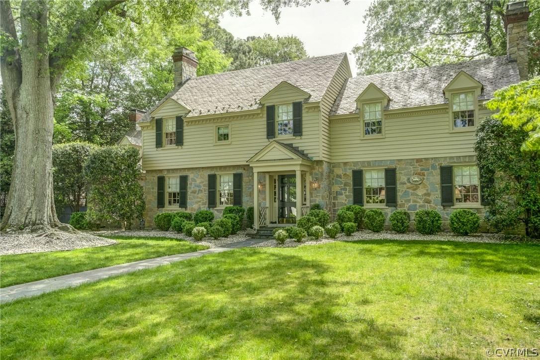 Curb appeal of a Pennsylvania main line home with stone and wood façade on a large flat lot and quie