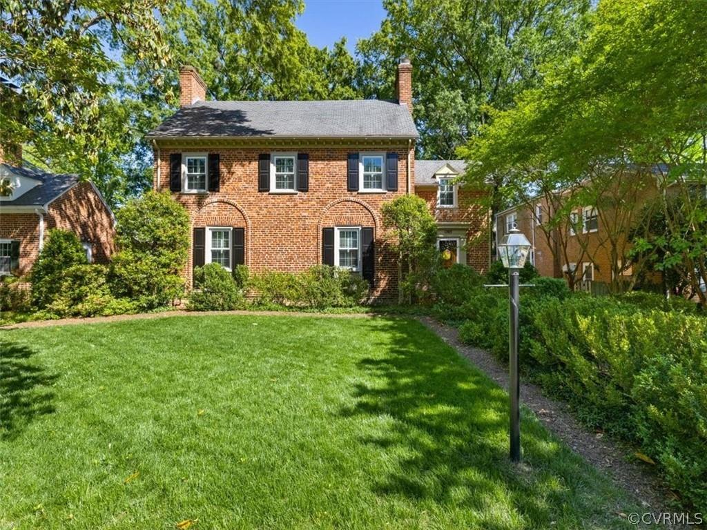 Stroll up the walk through the boxwoods to this stately all brick colonial with a slate roof in the 