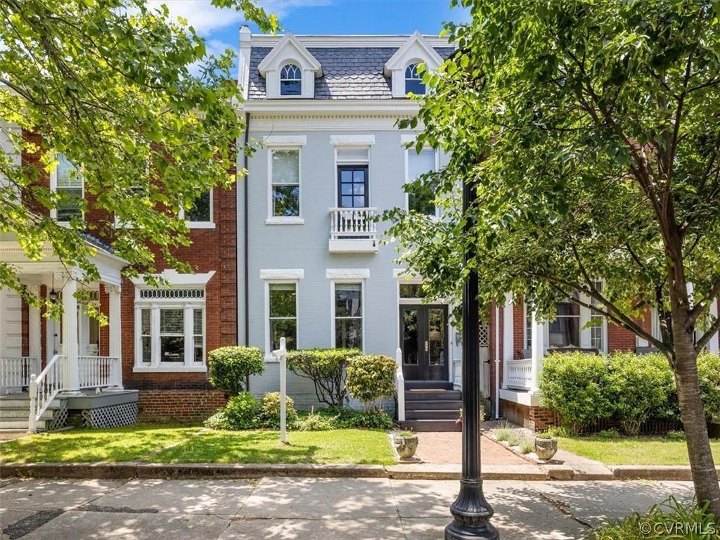 Situated on a beautiful block of W. Grace Street, this classic brick row home offers location & all 