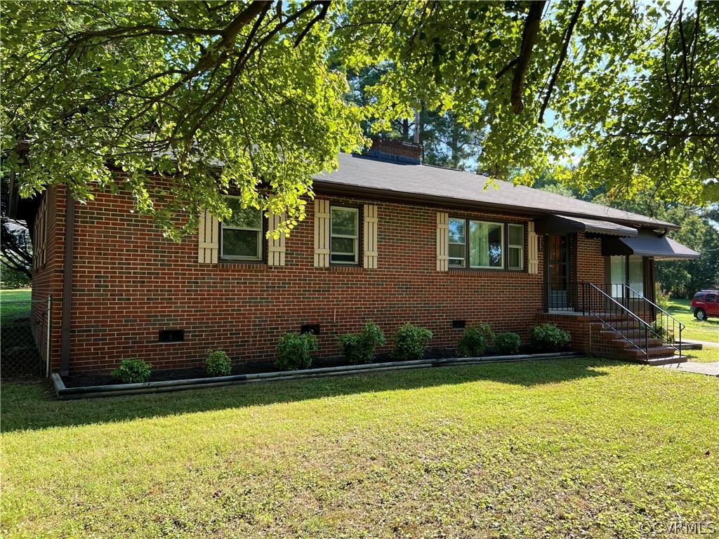 Super cute ranch style home with detached garage and carport!   Brick exterior, paved driveway, and 