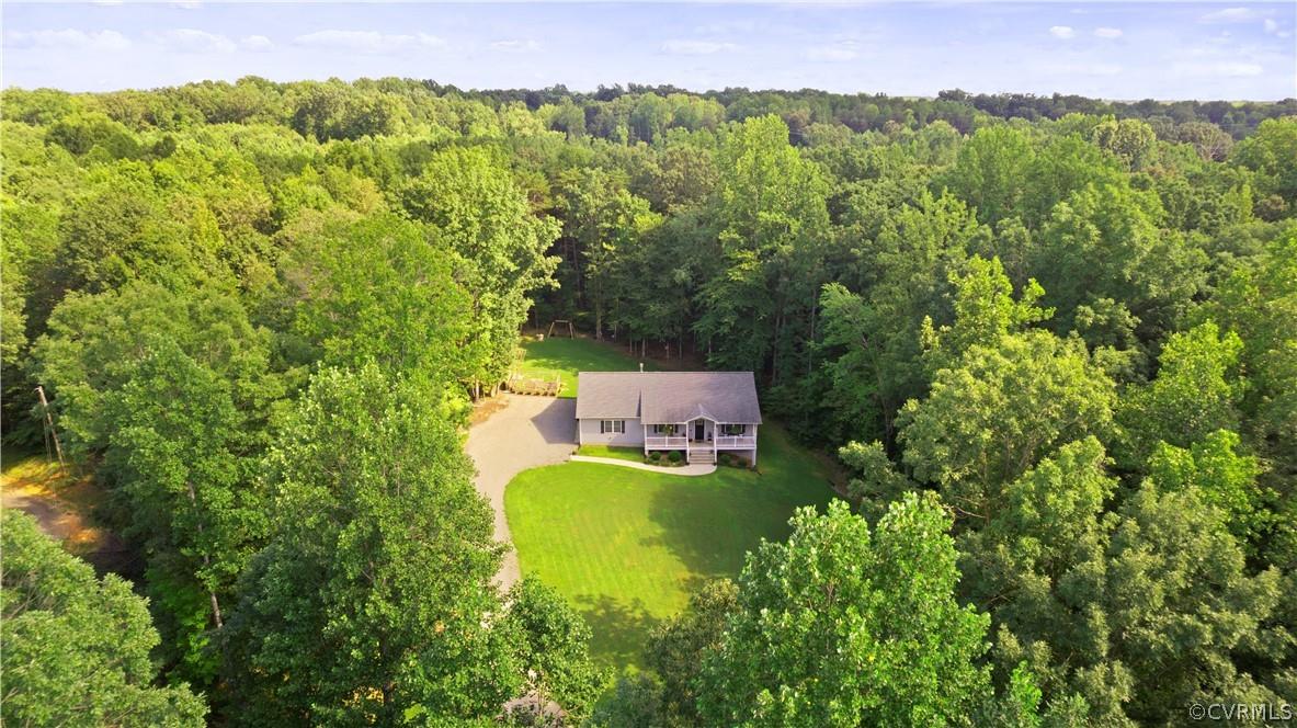 Just Listed! Welcome to 4746 Bell Road in Western Powhatan County. This one-owner ranch home consists of 3 bedrooms & 2 full bathrooms over 1,488 sqft of single-level living space on a private & landscaped 1.41 acre lot. Originally built in 2016 by Nichols Construction this like-new home has been beautifully maintained by the current owners and is truly move-in ready for the next owner! Upon entering you are greeted with hardwood floors & a vaulted ceiling in the open-concept living room with gas fireplace. The eat-in kitchen has upgraded cabinets, granite counters, stainless steel appliances, pantry & a dining area that walks-out to the covered rear porch & patio. The primary bedroom suite has a walk-in closet, custom built-ins & an ensuite bathroom with oversized set-in shower. The home is completed with 2 additional bedrooms with a shared full hallway bathroom.  A pull-down attic & 1.5 side-entry garage give ample storage options. The beautiful grounds are complimented with a private backyard swing, firepit & raised bed garden. Quick Powhatan dining & shopping options along Anderson Highway and just 30 minutes to Midlothian & 45 minutes to Downtown Richmond. Comcast at street!