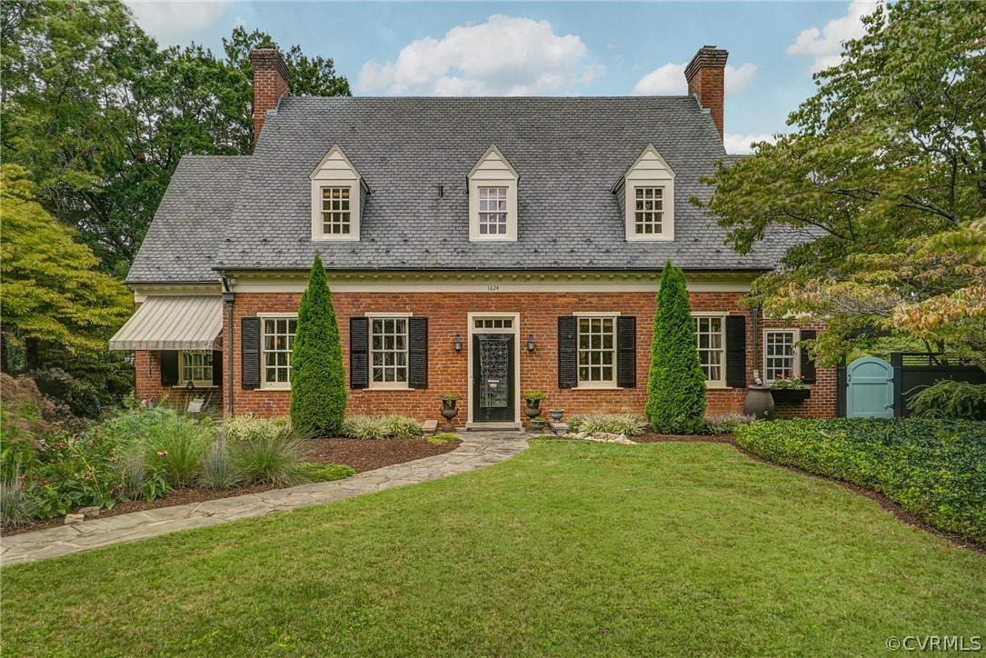 This brick-and-slate Cape with a raised rear dormer offers a rare opportunity to live on the coveted