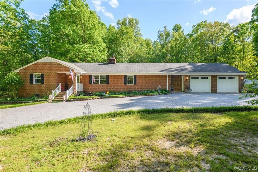 Beautifully Remodeled Brick Ranch on 3.36 Acres in Midlothian/Powhatan! Formal Living & Dining Areas with arched openings & columns; Remodeled Granite Kitchen with Tile Floor, handsome raised panel Cabinets, stainless steel Appliances, 8 x 3 Granite Center Isle, and 8 ft Granite Peninsula/Bar facing the Family Room; Family Room with Gas Fireplace and beautiful Pool views; Florida Room with Vaulted Ceiling & Skylights walks out to Patio; Primary Bedroom with remodeled Tile luxury Bath & Walk-in Closet; Separate Bedroom Suite with private entrance from Garage, Full Bath & Walk-in Closet (ideal for Guest Suite, Inlaw Suite, Home Office, etc).  Alluring hardscapes with Concrete Patio Areas surrounding the 40 x 24 Inground Pool.  Long gravel Drive through serene woods leads to Circular Stamped Concrete Paved Driveway; Oversized Two Car Garage; Two Detached Sheds (18x10 and 12x9);  Generator operates by Propane; Convenient location just over the Chesterfield County Line in Powhatan County with easy access to the 288/Robious/Huguenot Trail Interchange, Watkins Landing for James River Access, and minutes to Westchester Commons and Short Pump Town Center.