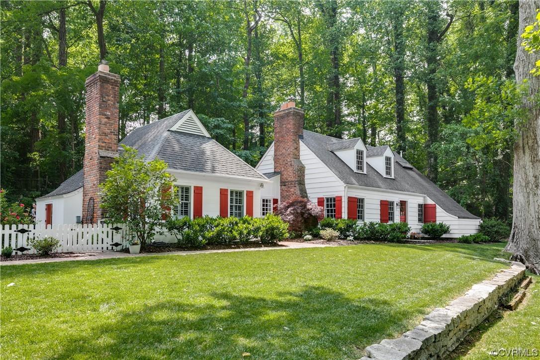 Perched on a private hillside just steps from the James, this lovely original river cottage feels li