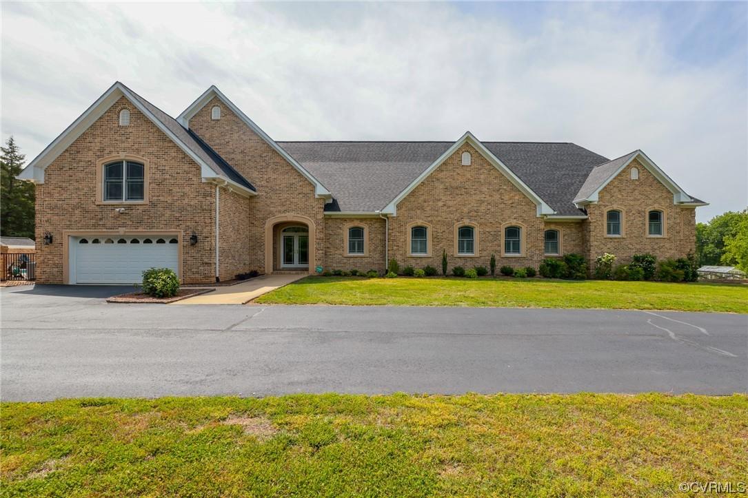 Escape to your own retreat, this quality built, custom brick and stone home, sited on 10.4 rolling a